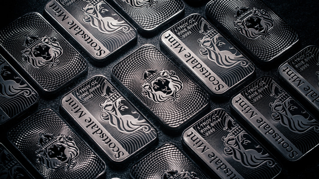 Multiple Scottsdale 1 oz Silver Bars displayed on dark background