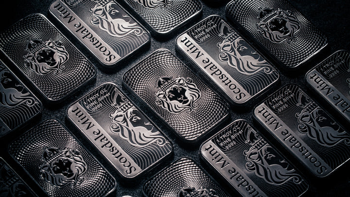 Multiple Scottsdale 1 oz Silver Bars displayed on dark background